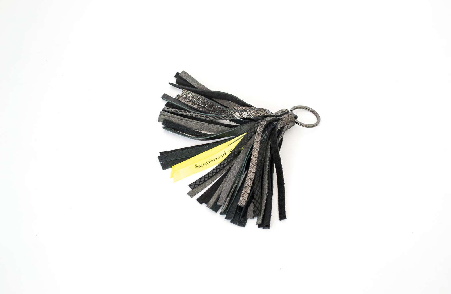 shiny-black-tassel Tassel crafted with black leather in various textured finished with a golden keyring.